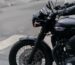 Close-up of a classic black motorcycle on a city street, perfect for urban adventure themes.