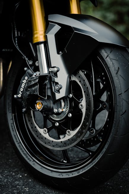 Detailed view of the front wheel and Brembo brake on a Suzuki motorcycle.