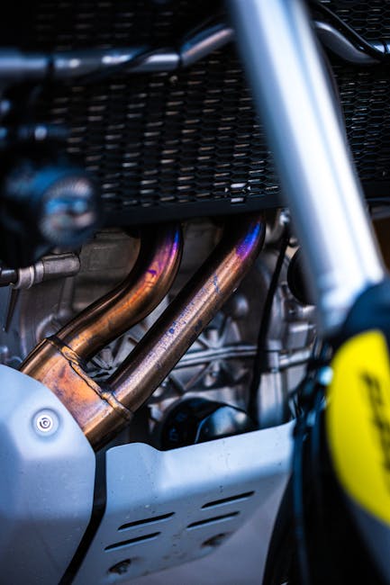 Detailed view of motorcycle engine pipes highlighting metallic textures.