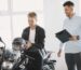 Two men at a motorcycle dealership discussing a motorbike purchase.