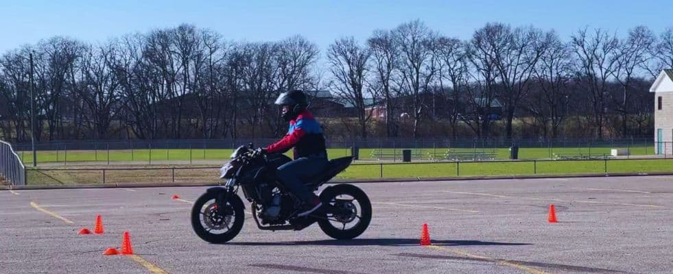 Rider braking hard on a motorcycle during a controlled test