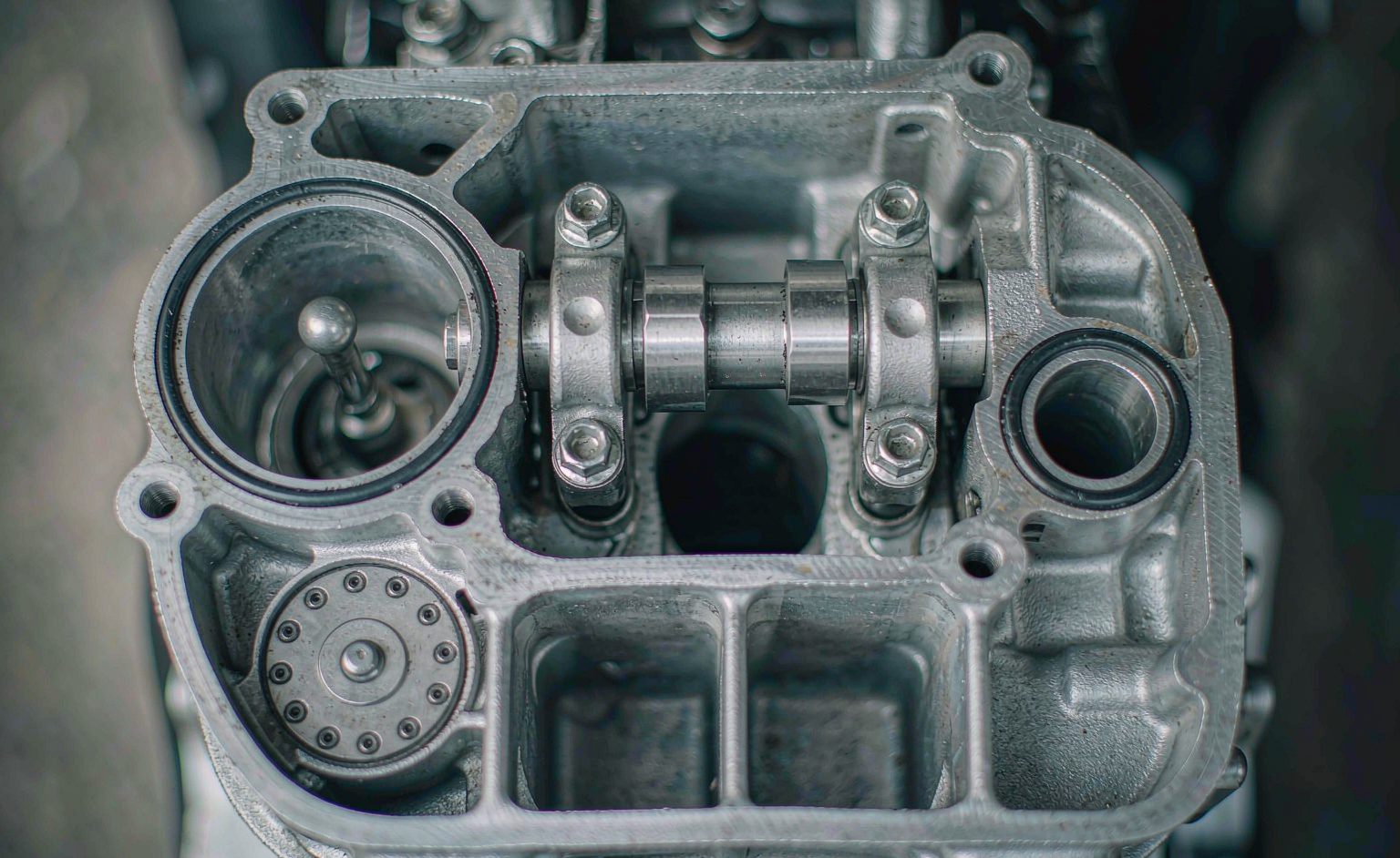 Motorcycle engine cylinder head with valve cover removed for clearance adjustment